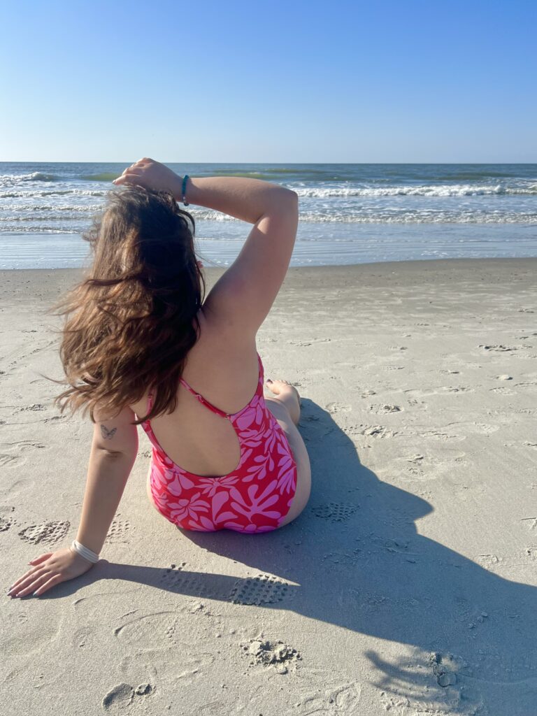Me in a hot pink swimsuit facing out to the Atlantic Ocean